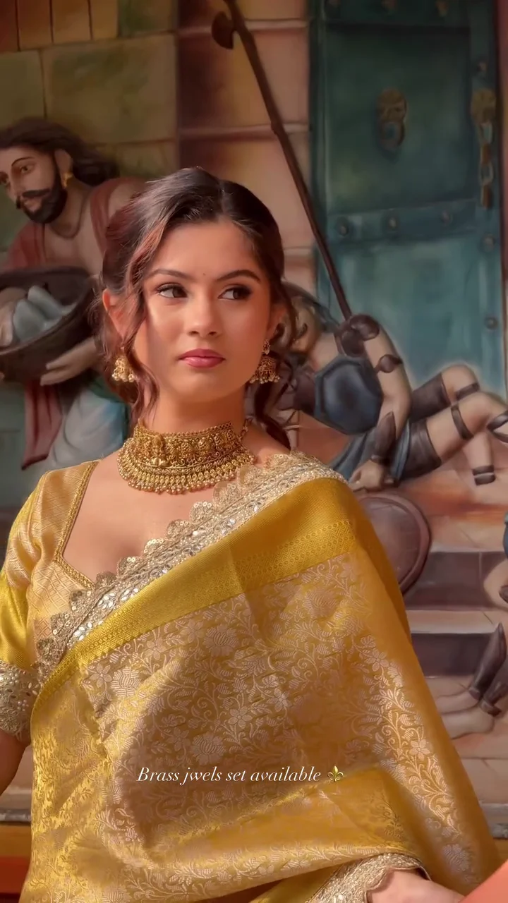 Elegant Gold Banarasi Saree with Traditional Brass Jewelry